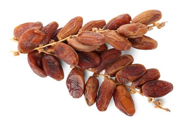 Photo of Sweet dates on branches against white background, top view. Dried fruit as healthy snack