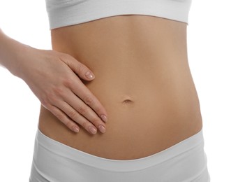 Photo of Woman holding hand on belly against white background, closeup