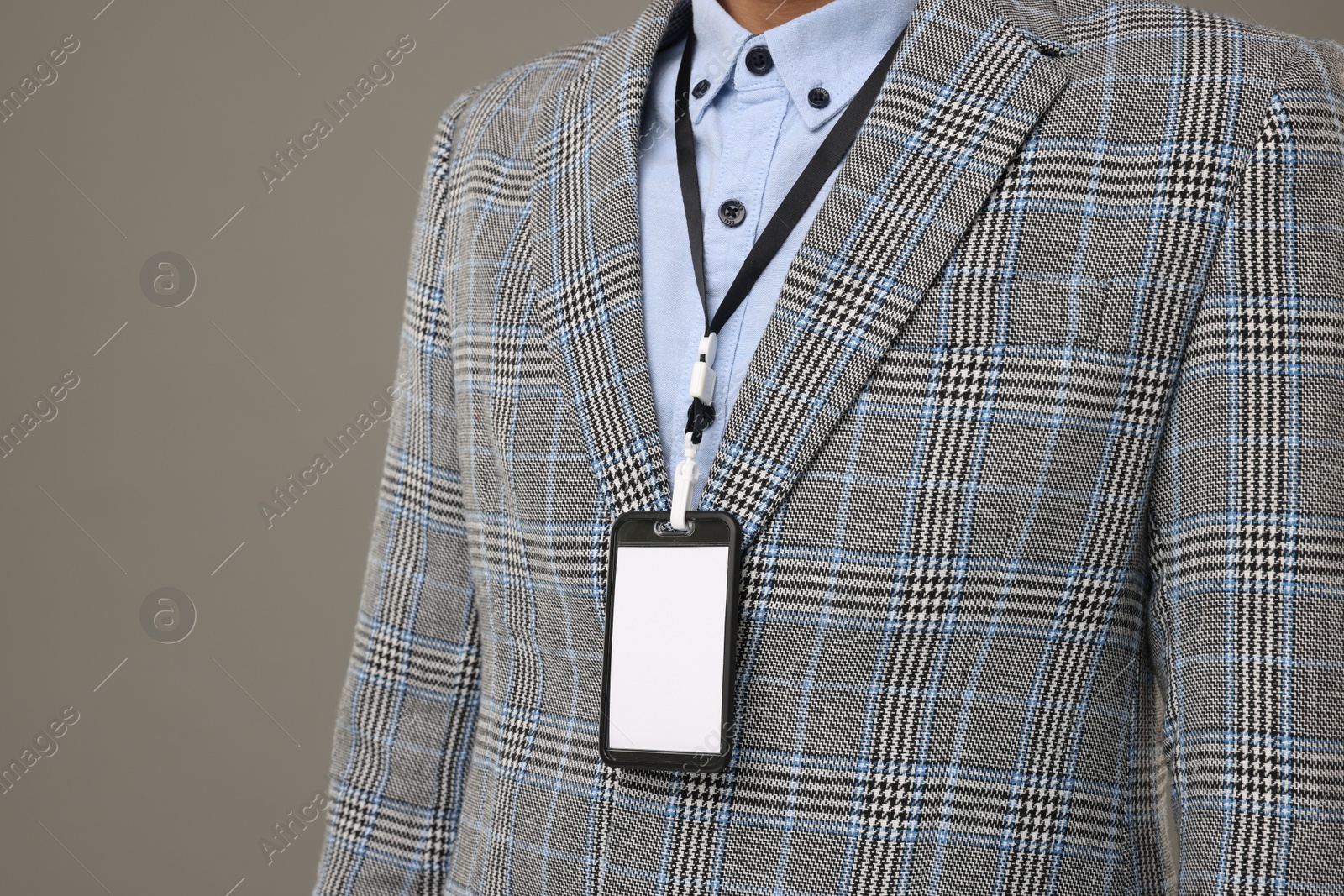 Photo of Man with blank badge on grey background, closeup. Space for text