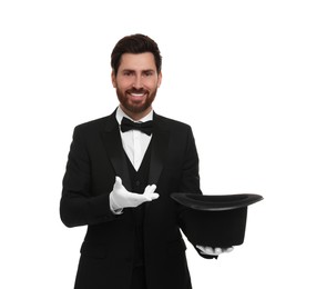 Photo of Happy magician holding top hat on white background