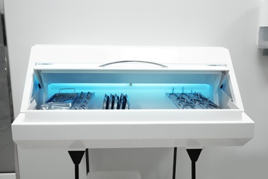 Photo of Ultraviolet sterilizer with ENT medical instruments in clinic