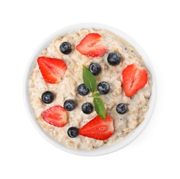 Photo of Tasty boiled oatmeal with berries in bowl isolated on white, top view