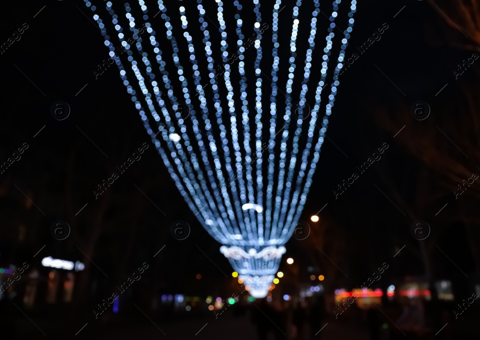 Photo of Beautiful bright Christmas decor outdoors, low angle view. Bokeh effect