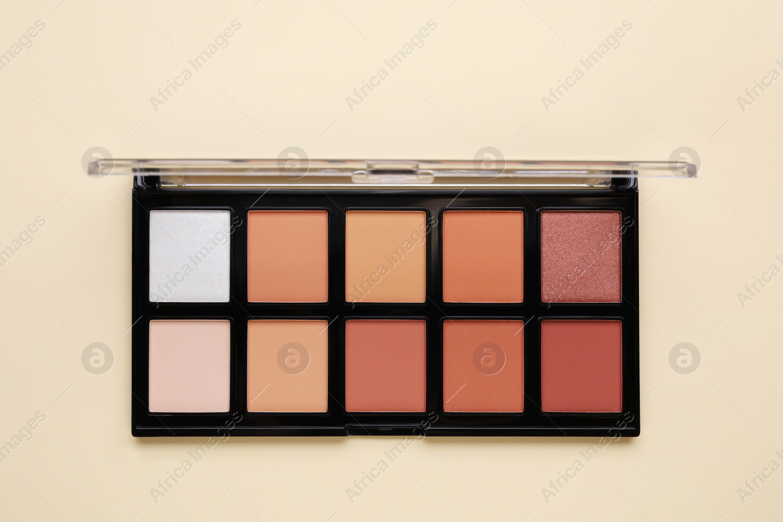 Photo of Colorful contouring palette on beige background, top view. Professional cosmetic product