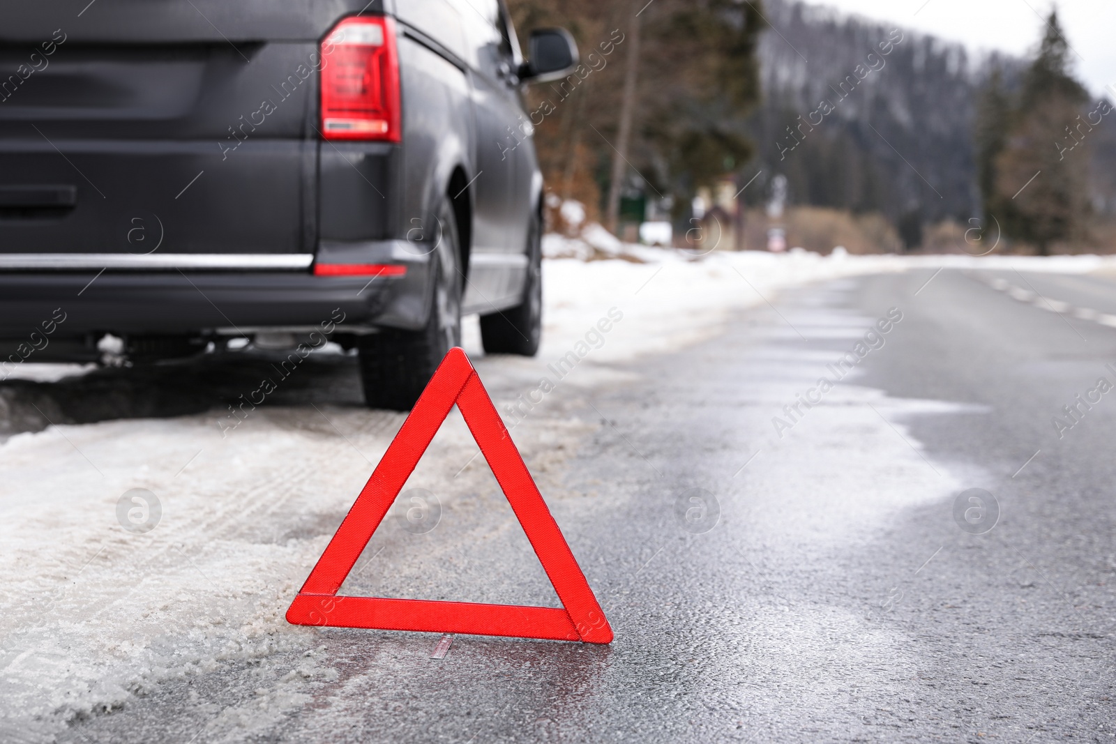 Photo of Emergency stop sign and broken car on winter day