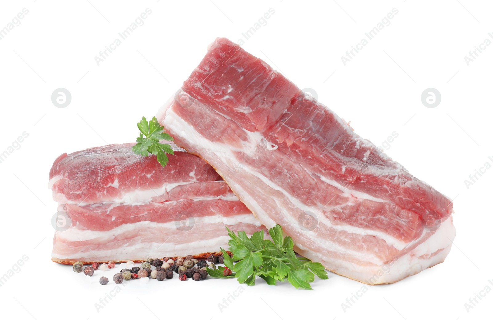 Photo of Pieces of raw pork belly, peppercorns and parsley isolated on white