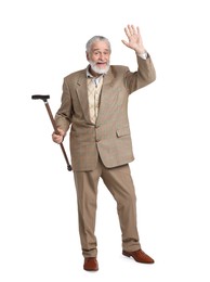 Senior man with walking cane waving on white background