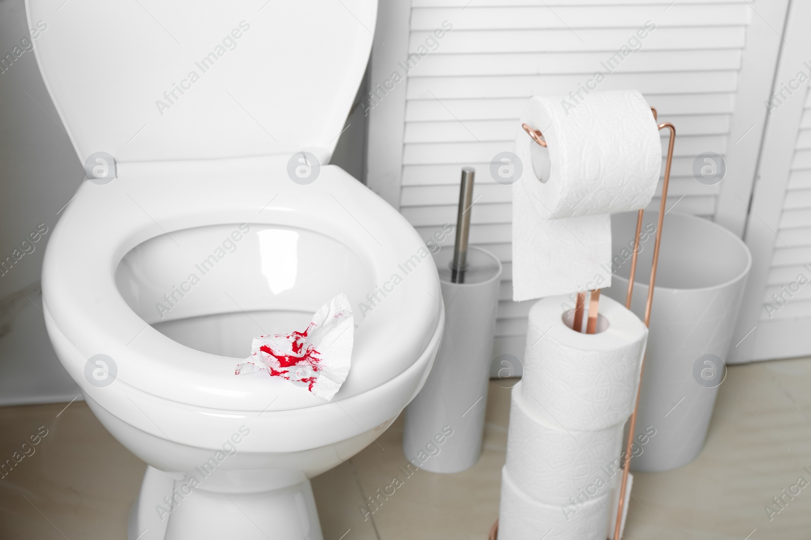 Photo of Sheet of paper with blood on toilet seat in bathroom