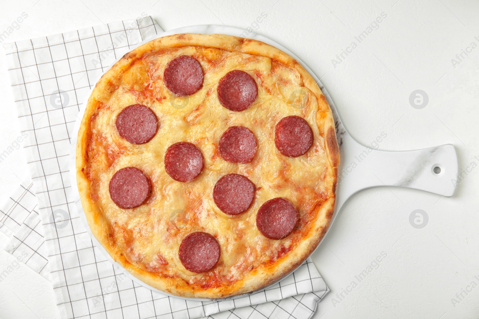 Photo of Tasty pepperoni pizza on white table, flat lay