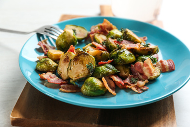 Photo of Roasted brussels sprouts with bacon on plate, closeup