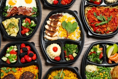 Photo of Lunchboxes with different meals on table, flat lay. Healthy food delivery