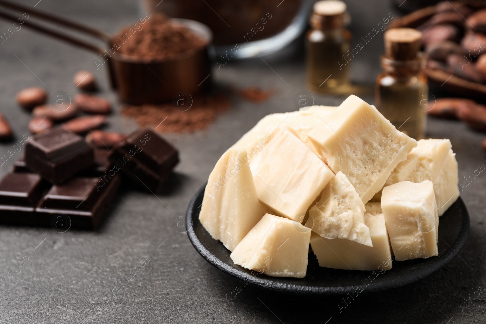 Photo of Organic cocoa butter in plate on grey table