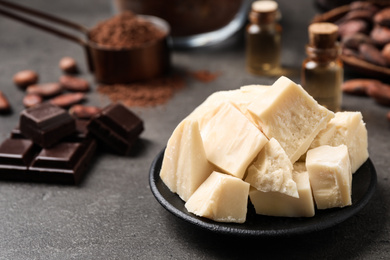 Organic cocoa butter in plate on grey table