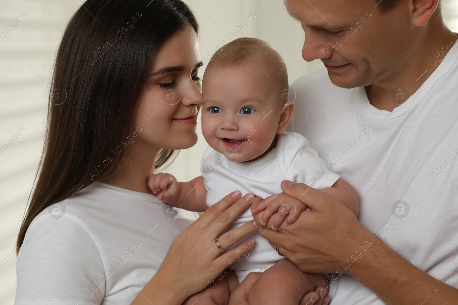 Photo of Happy family. Couple with their cute baby, closeup