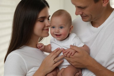 Happy family. Couple with their cute baby, closeup