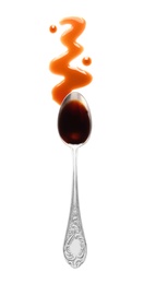 Traditional soy sauce and spoon on white background, top view