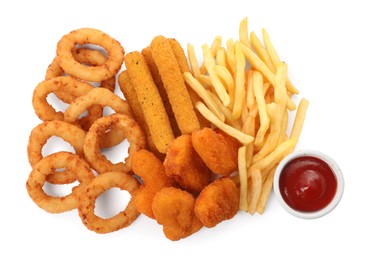 Different delicious fast food served with ketchup on white background, top view