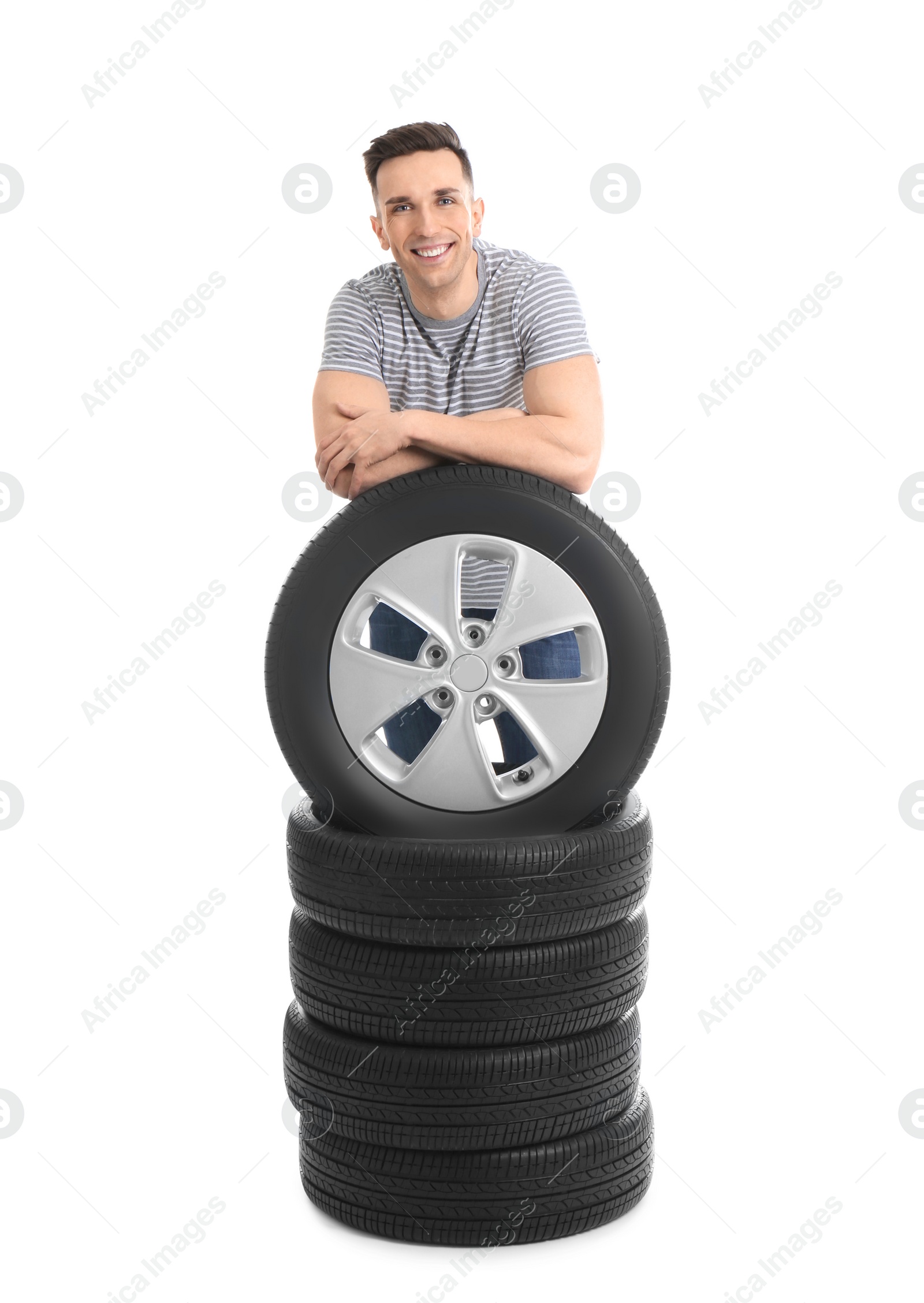 Photo of Young man with car tires on white background