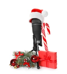 Microphone with Santa hat, gift box, candy cane and festive decor on white background. Christmas music