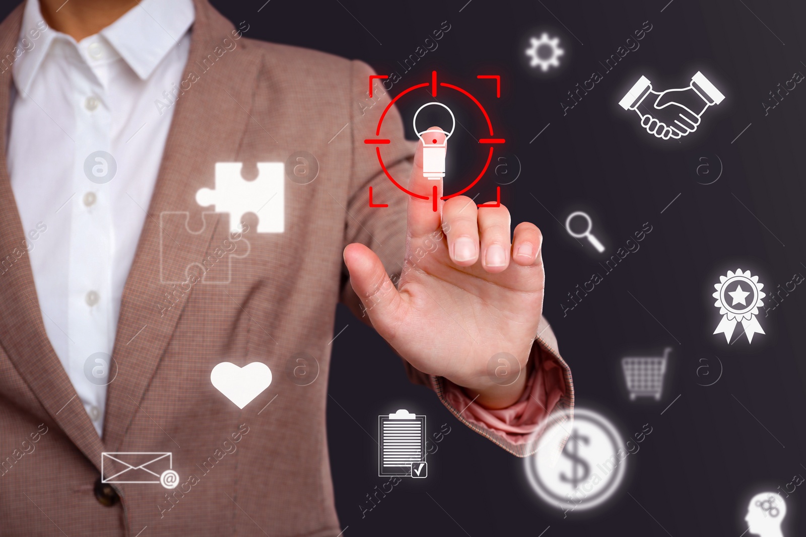 Image of Woman touching light bulb icon in target on digital screen against dark background, closeup