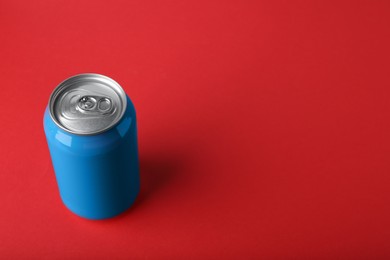 Photo of Blue can of energy drink on red background. Space for text