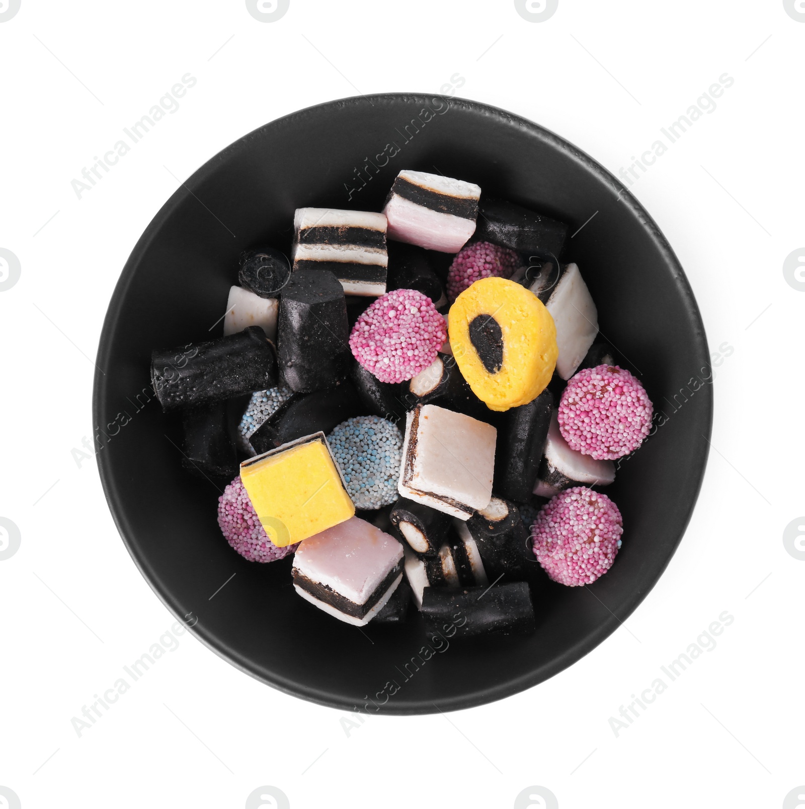 Photo of Bowl with many tasty liquorice candies isolated on white, top view