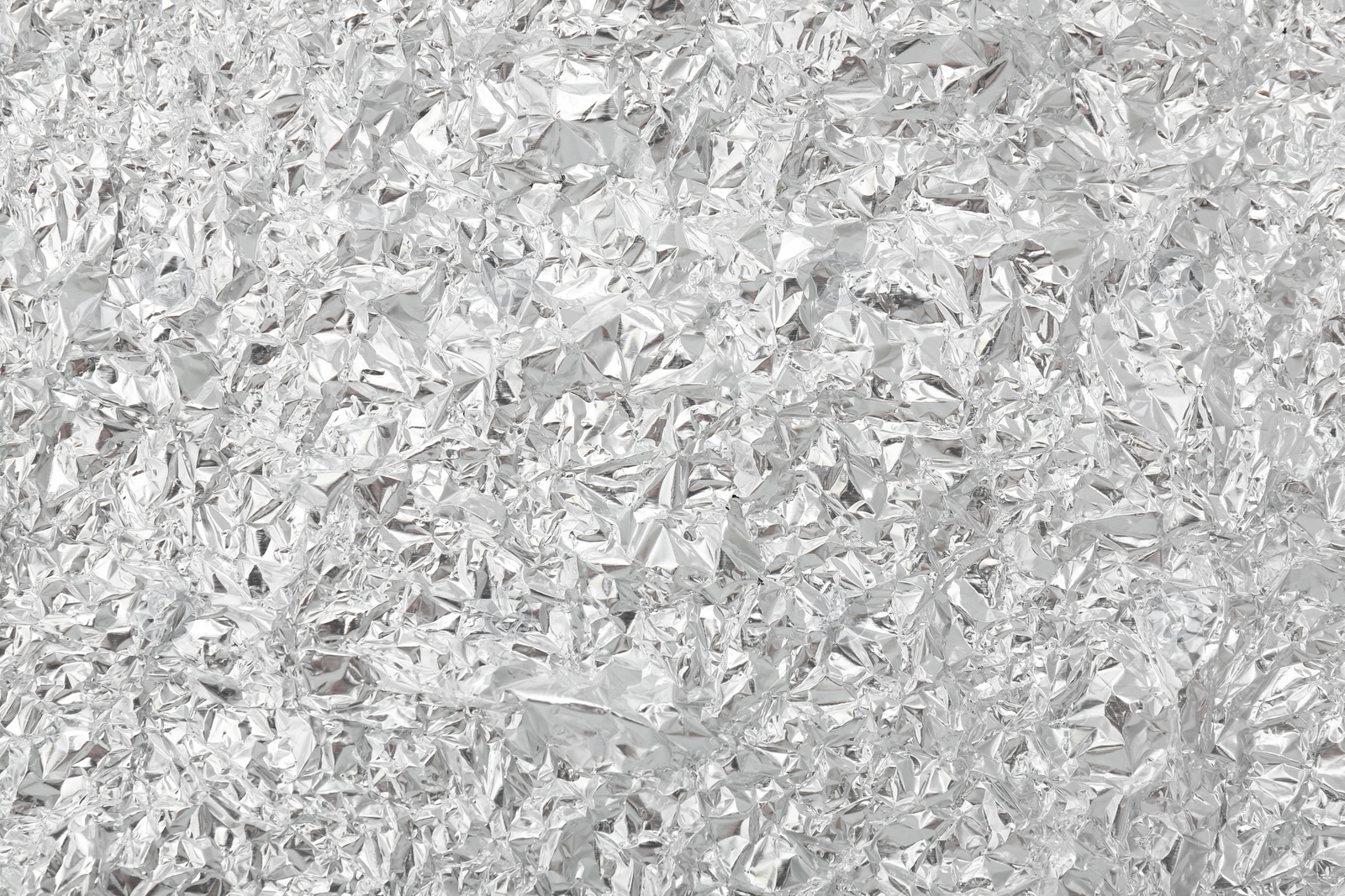 Photo of Crumpled silver foil as background, top view