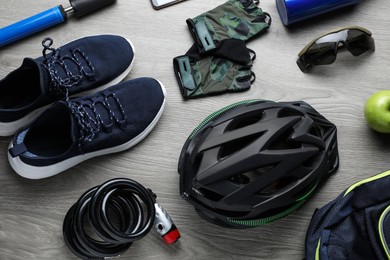 Photo of Flat lay composition with different cycling accessories on wooden background