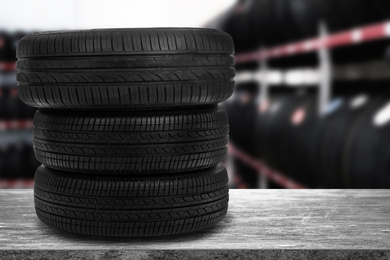Image of Car tires on grey stone surface in auto store