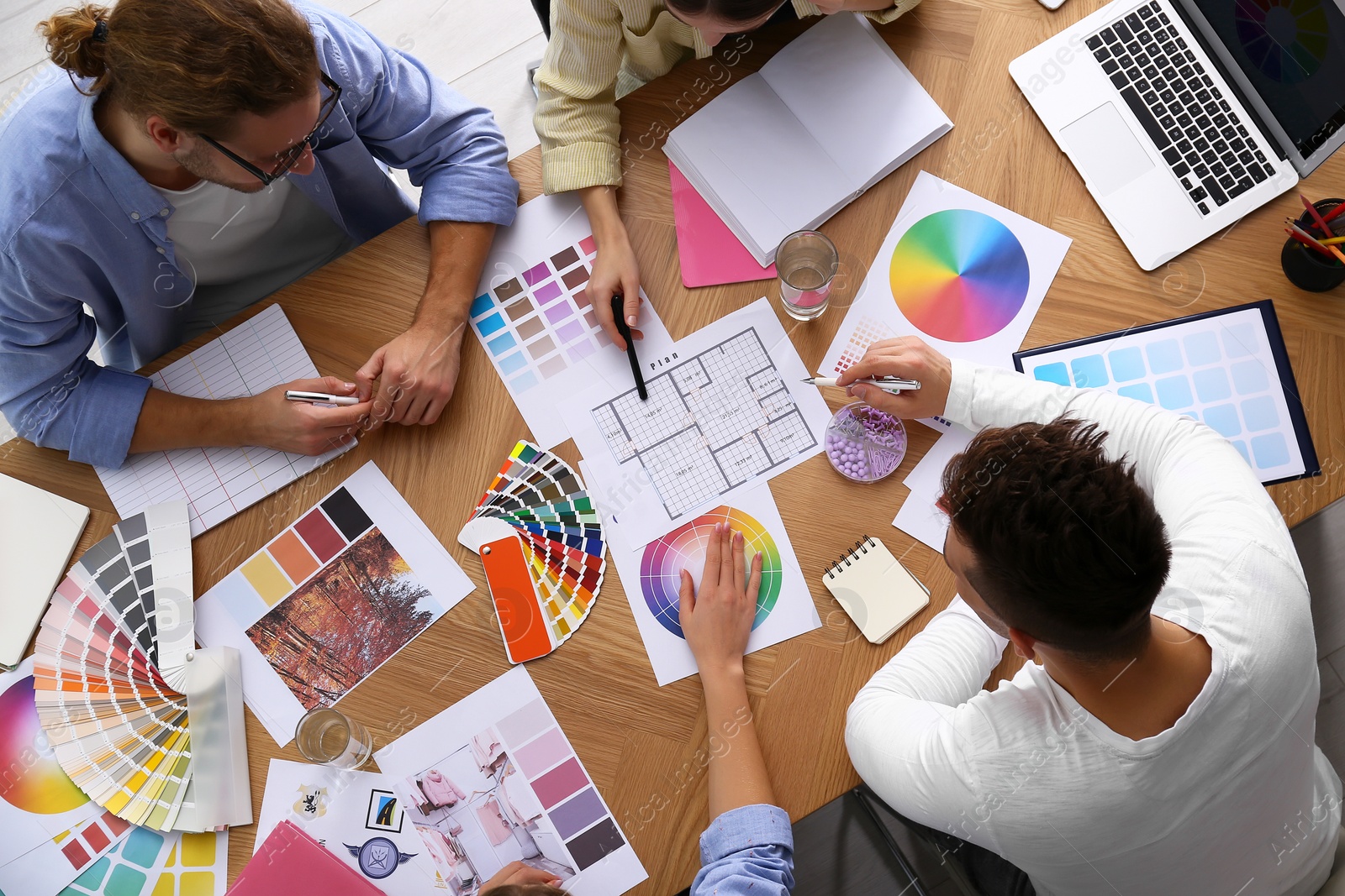 Photo of Professional team of interior designers working at table, top view