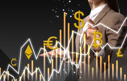 Image of Cryptocurrency. Businesswoman using virtual screen with currency symbols and graphs against dark grey background, closeup