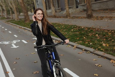 Photo of Happy beautiful woman with bicycle on lane in city