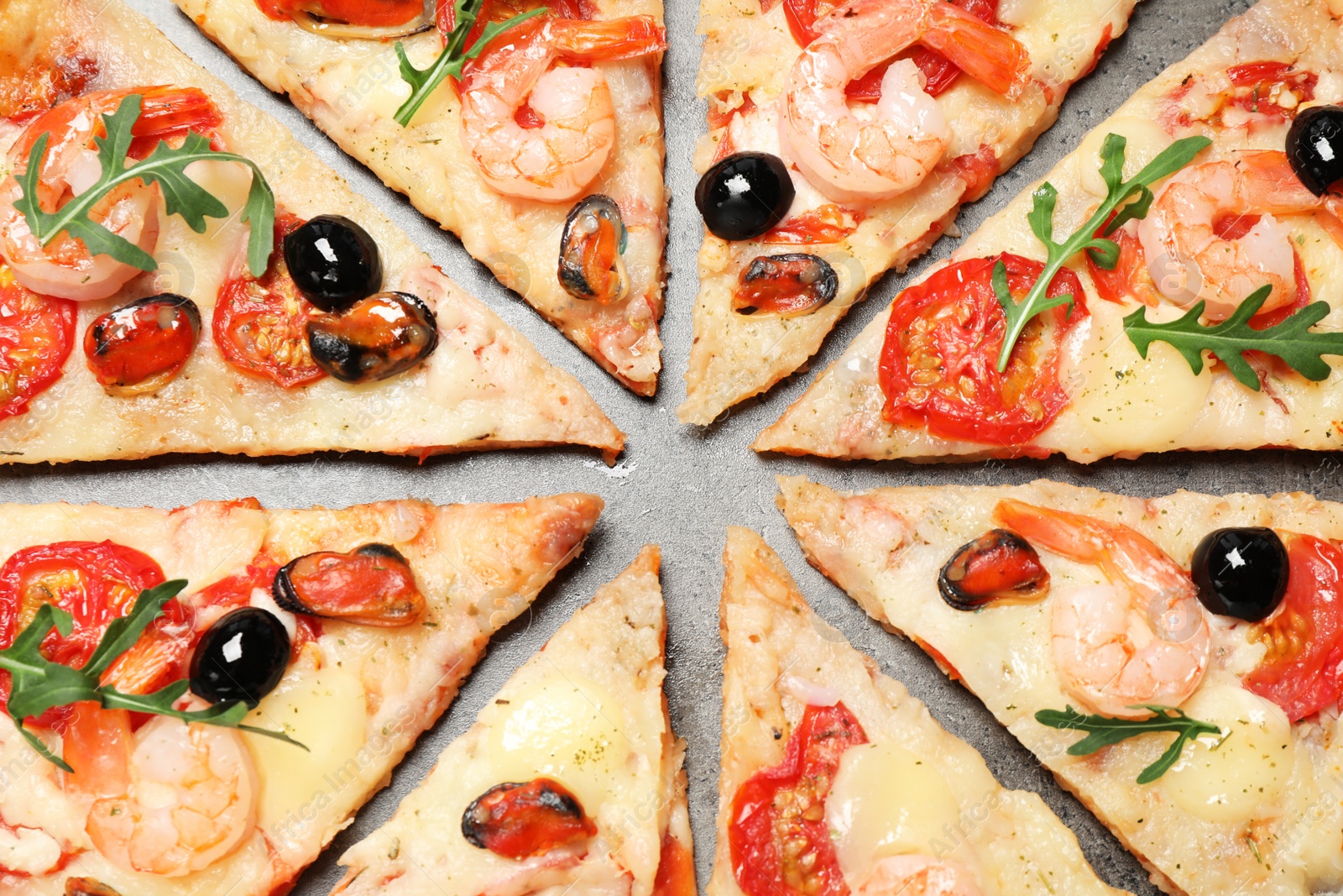 Photo of Tasty pizza with seafood on grey table, flat lay