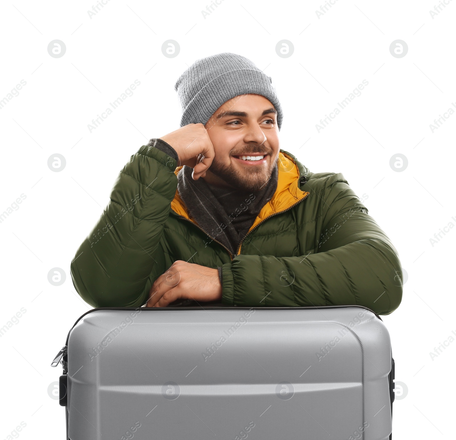 Photo of Young man in warm clothes with suitcase on white background. Winter vacation