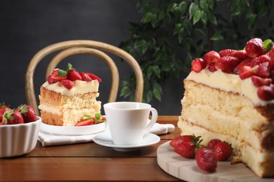 Tasty cake with fresh strawberries, mint and cup of drink on wooden table