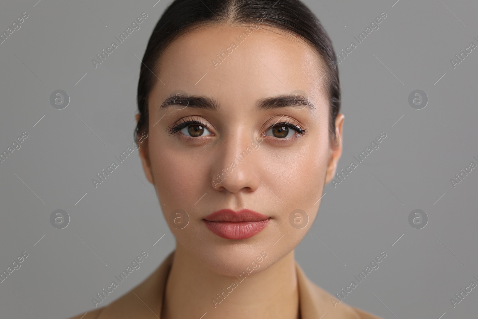 Photo of Portrait of beautiful young woman on grey background, closeup