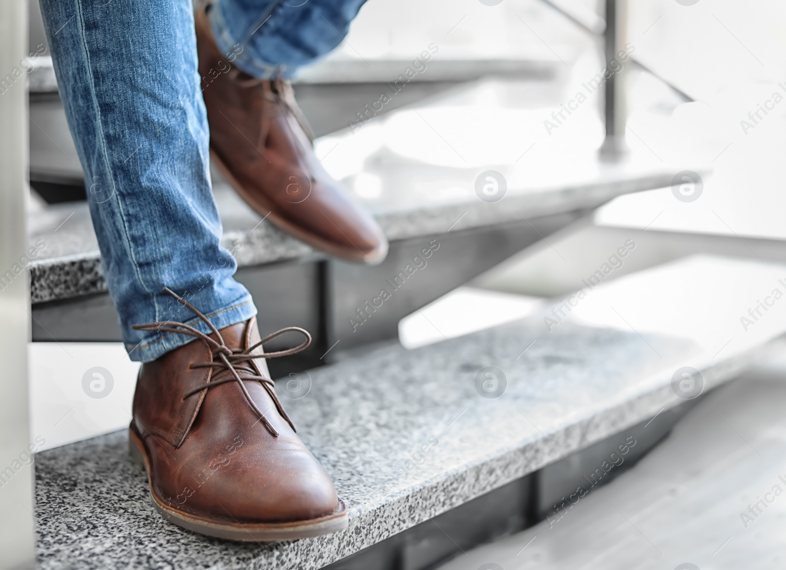 Photo of Man in in elegant shoes walking down stairs indoors