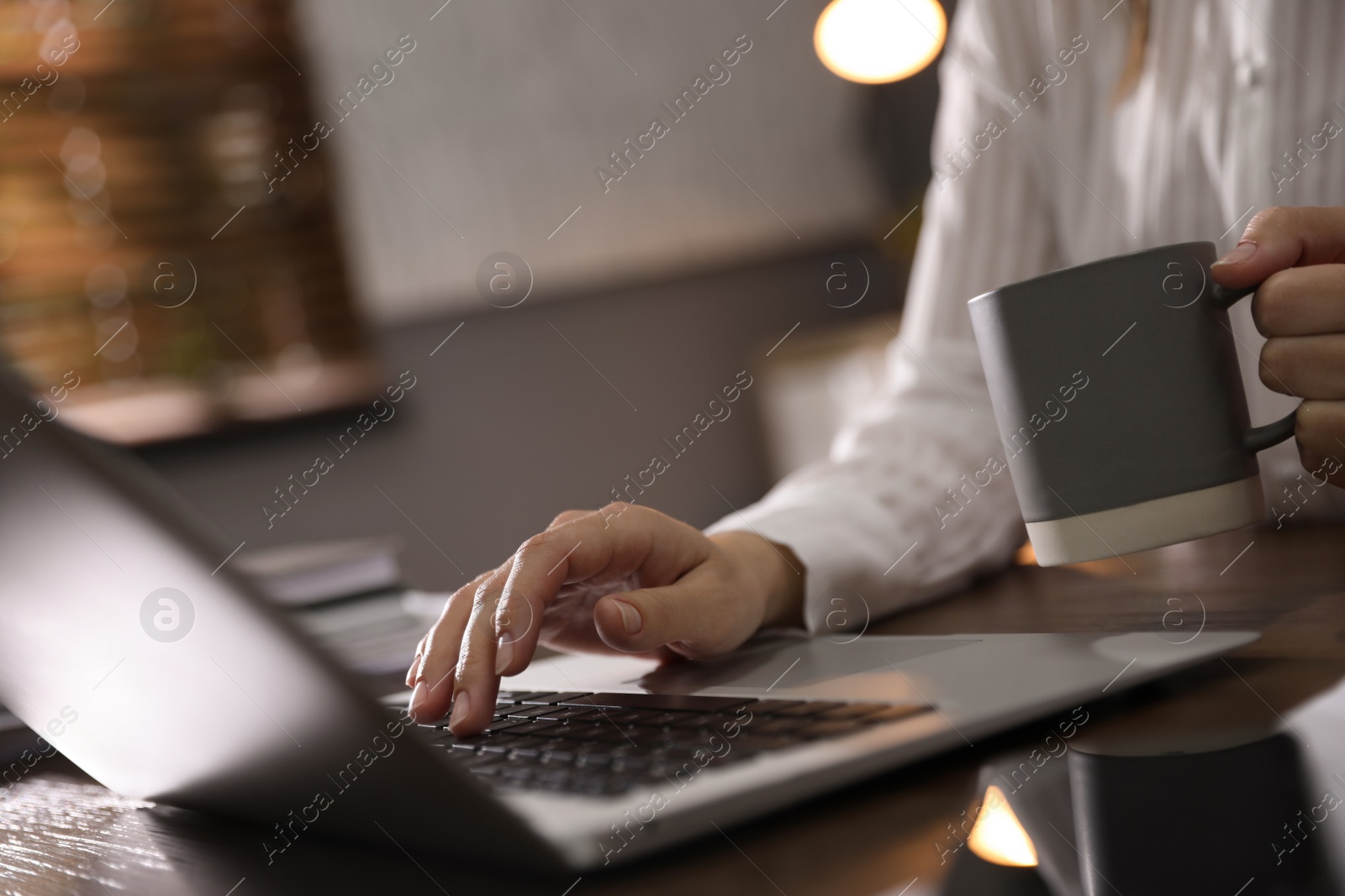 Photo of Woman working with laptop in office, closeup of hands