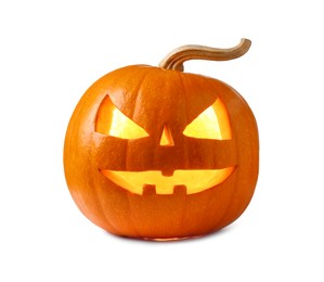 Photo of Carved pumpkin for Halloween lit from within by candle isolated on white