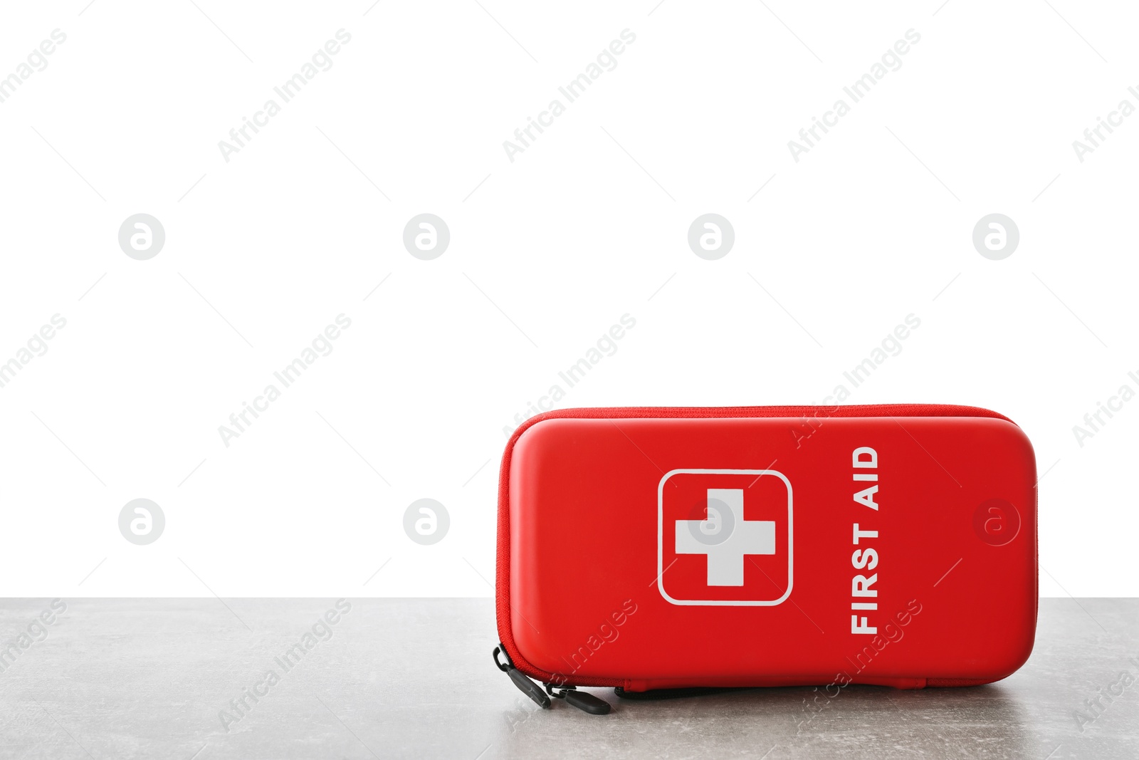 Photo of First aid kit on light grey table against white background