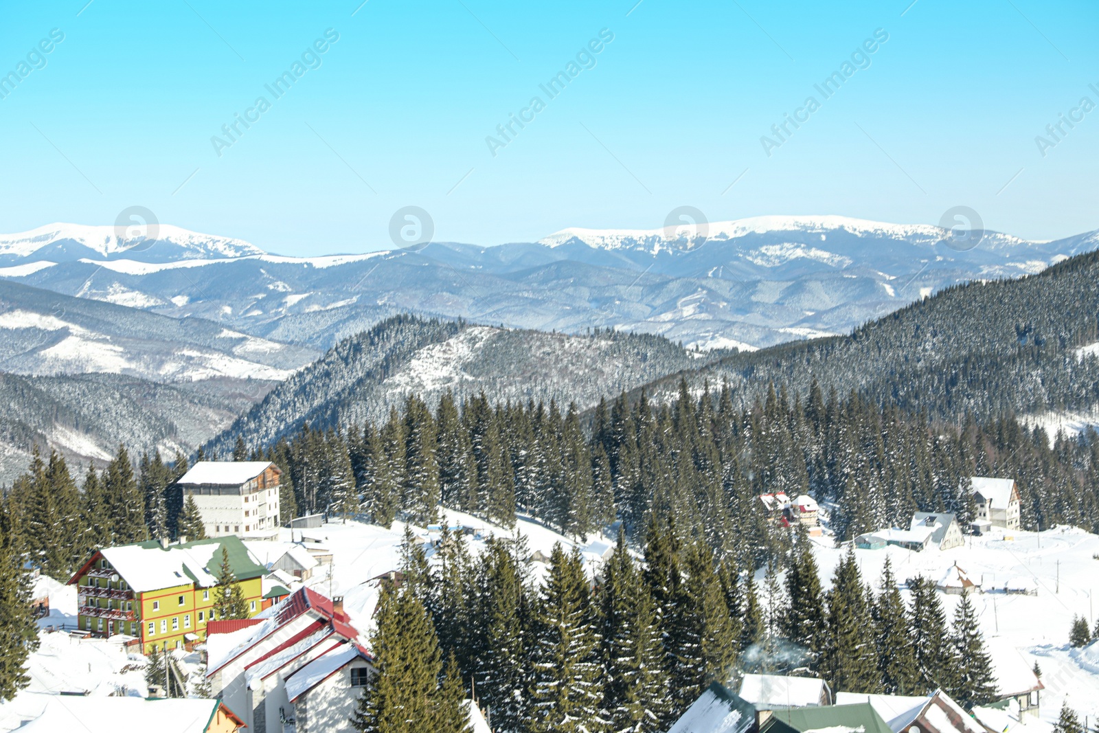 Photo of Modern hotels in snowy mountains on winter day