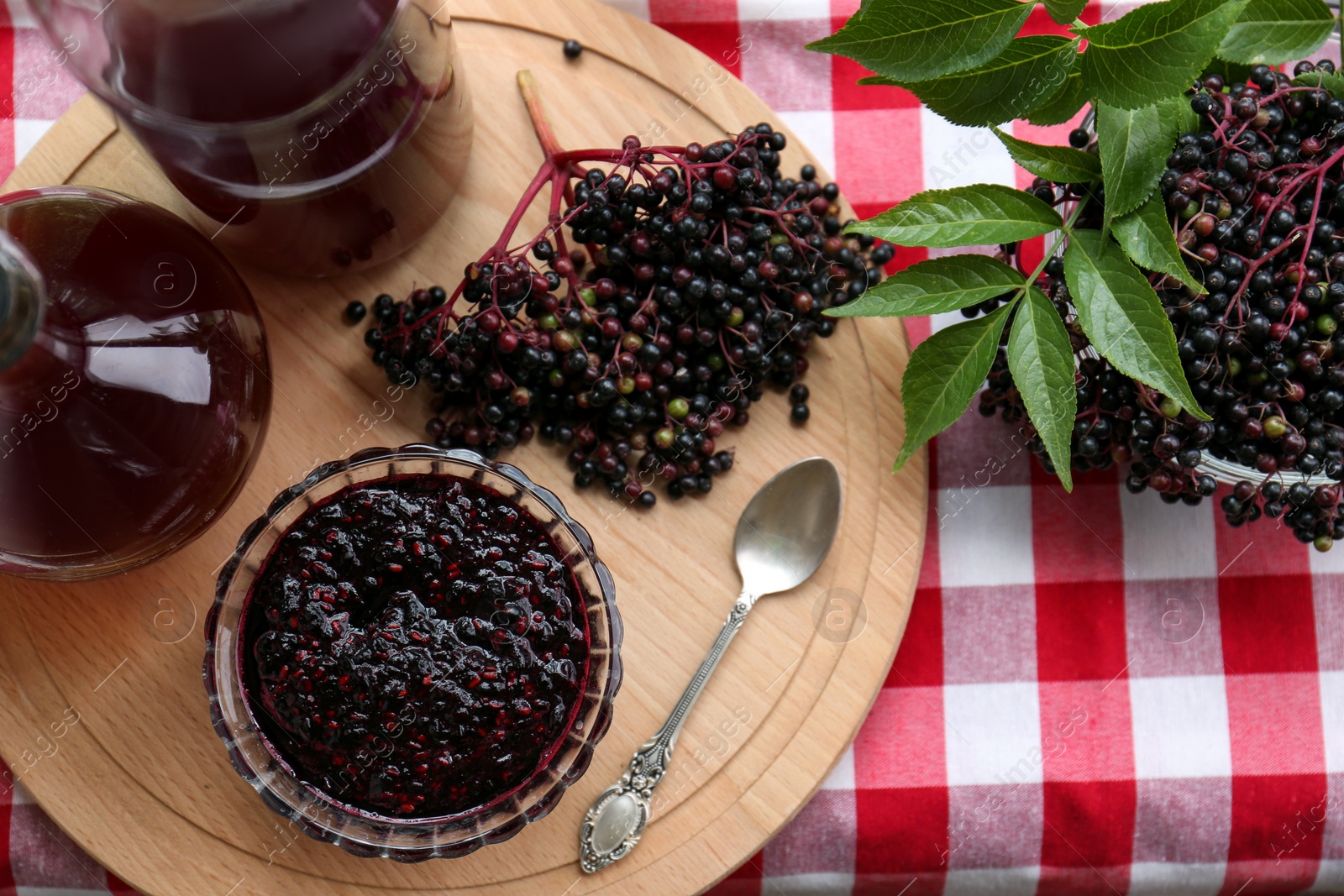 Photo of Elderberry drink and jam with Sambucus berries on table, flat lay