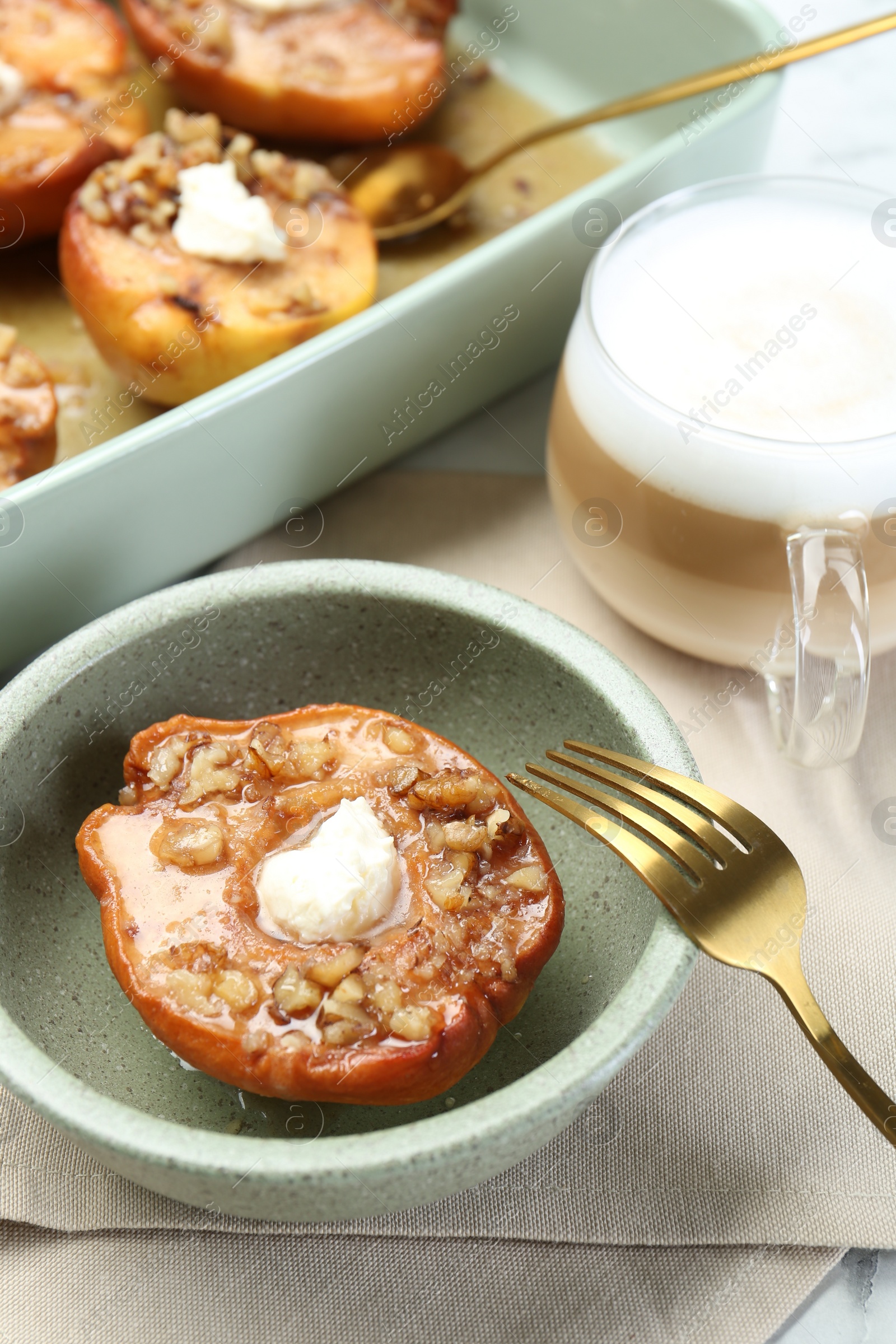 Photo of Tasty baked quinces with nuts and cream cheese served on table