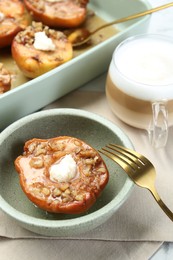 Photo of Tasty baked quinces with nuts and cream cheese served on table