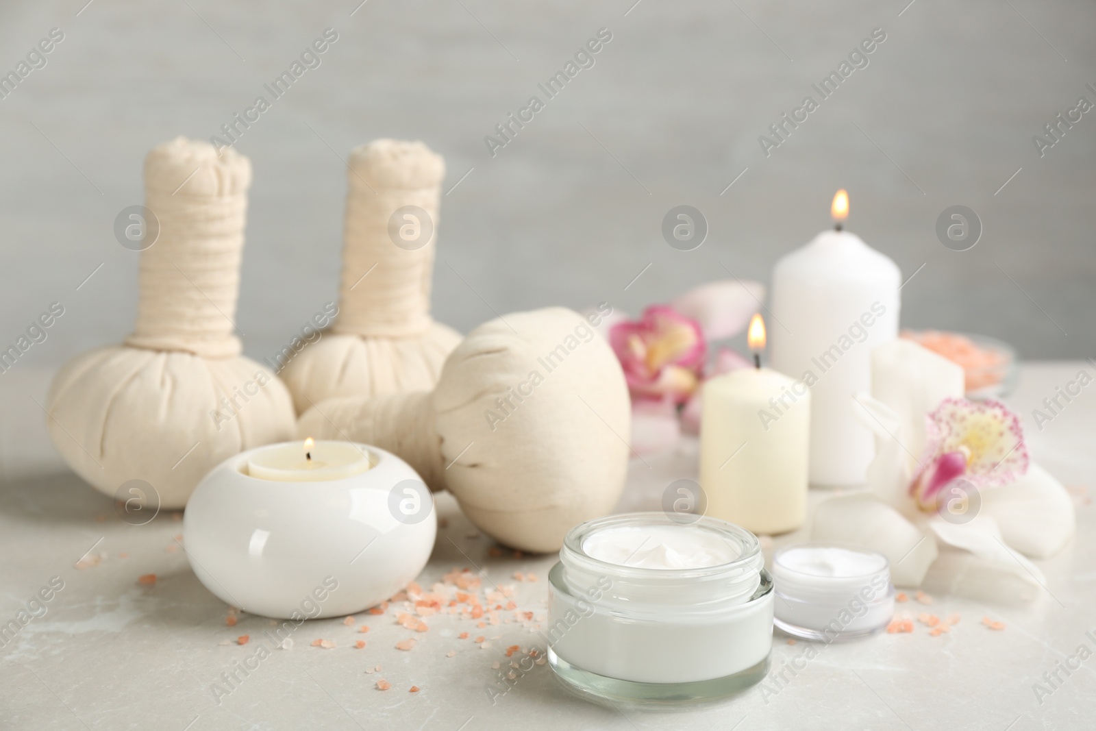 Photo of Beautiful spa composition with skin care products and candles on marble table