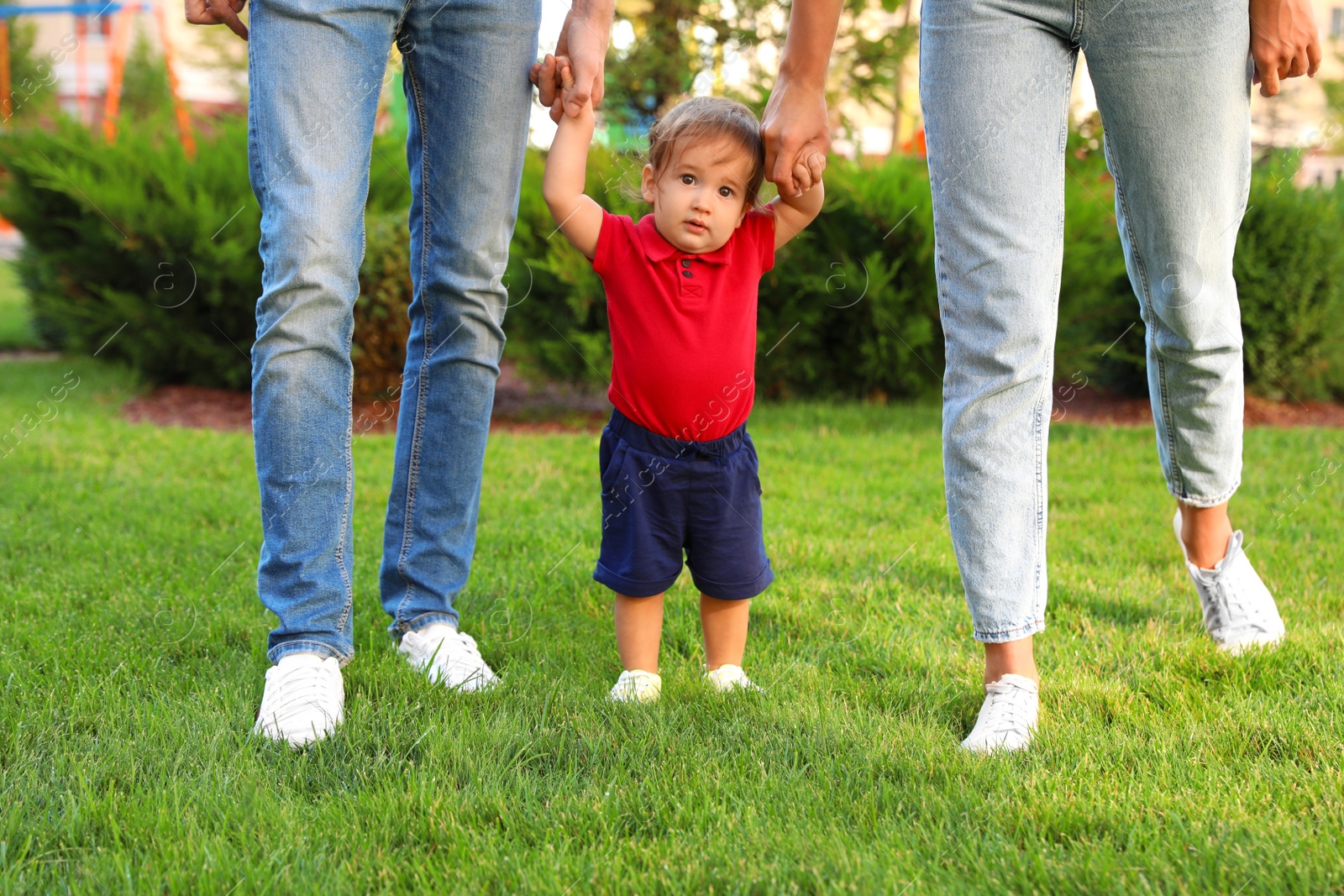 Photo of Happy family with adorable little baby outdoors