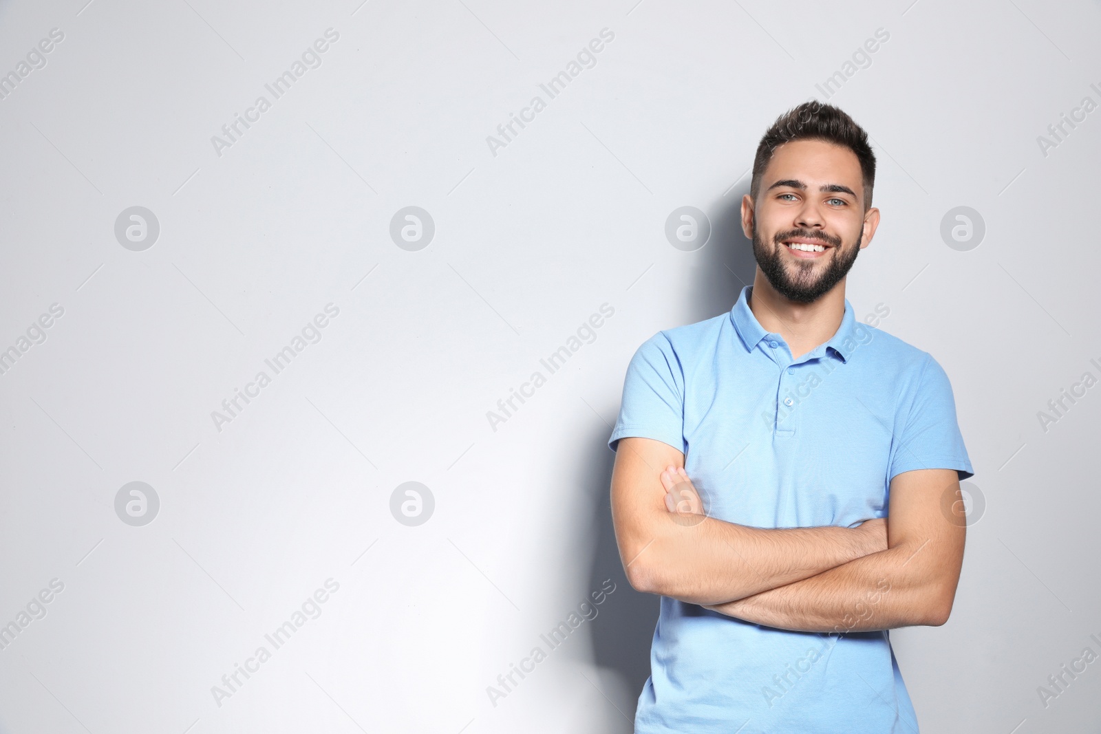 Photo of Portrait of handsome young man against light background. Space for text