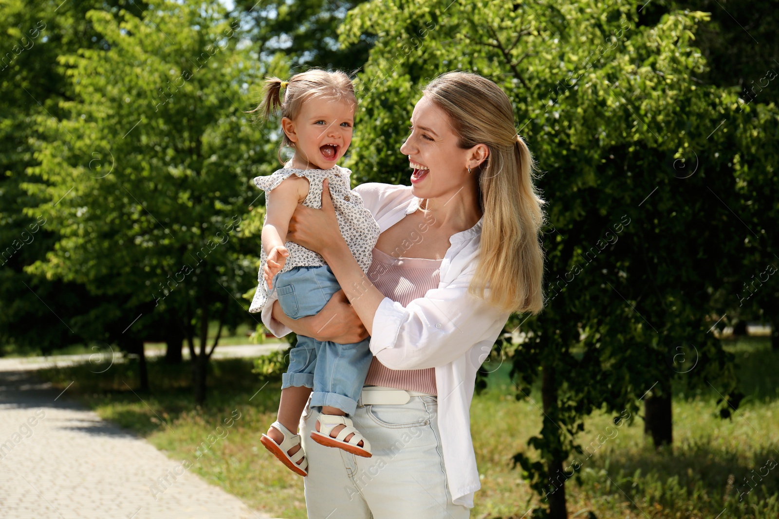 Photo of Happy mother with her daughter having fun in park