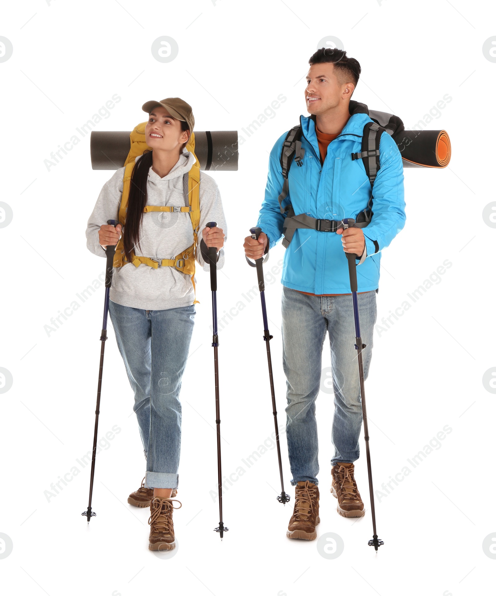 Photo of Couple of hikers with backpacks and trekking poles on white background