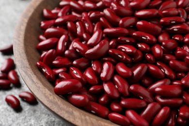 Raw red kidney beans in wooden bowl, closeup